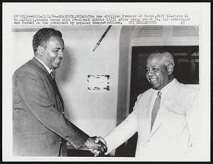 Khartoum, Sudan: The new civilian Premier of Sudan, Siff El-Khaim El Khalifa (L), shakes hands with President Abboud 10/31 after being sworn in. His nomination was forced on the president by popular demonstrations.