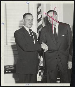 Dr. Roger J. Abizaid, left, is congratulated by Gov. Foster Furcolo on his appointment to a five year term as member of the Boston Finance Commission Dr. Abizaid was first named to the post by Gov. Paul A. Dever