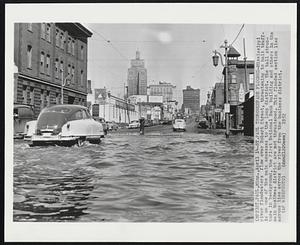 St. Paul Thoroughfare Flooded - Mississippi river floodwaters flow over Robert Street, threatening to halt traffic on one of the main accesses to the loop district. The tall structure in background, the First National Bank building and others in the main business district are not threatened. This flooded section lies across lies across the river from the business district