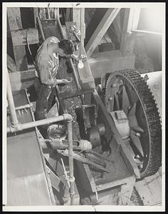 Paydirt rolls down into the crusher to be ground for further refining into pure gold.