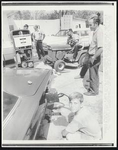 Scenes like this are being repeated all along the Mississippi coast because of the lack of electrical power. Gasoline shortage has become acute but enterprising station owners are using other means to pump the much needed fuel. As young Jimmy Taylor pours gas into a car, Buddy Morgan operates a lawnmower to make the pumps work. Electricity is out over a 30-mile coast stretch.
