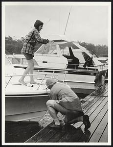 Monument Beach Y. C. Bourne. Jane Dawson age 21 and her father Howard Dawson tie up boat