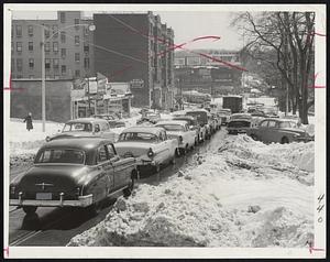 Cleveland Circle Jam - These cars waited long periods to only inch ahead on Chestnut Hill avenue toward the circle yesterday. A few of abandoned cars, some there since last Friday, may be seen at right.