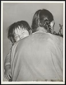 Heap Good Nap Swung on his mamma's broad shoudler, there's shut-eye in the making here as a papoose relaxes. Mother came for the traditional Festival of the Green Corn at Livingston, Tex., with others of the Alabama-Coushatti tribe. Green corn or no, a little grave must get his rest.