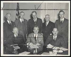 Mayor's Conference on Teachers' Pay Raises - Salary increases for Boston teachers which would cost $400,000 this year were discussed at City Hall today. Conferees, front row (left to right) were Michael J. Downey, assistant superintendent of schools; Mayor Kerrigan, and Budget Commissioner Herman L. Bush. Back row (left to right) Charles E. Lee, Boston Chamber of Commerce; John A. Sullivan, budget technician; City Auditor Charles J. Fox, Robert E. Cunniff, secretary of Boston Finance Commission, and John J. Costello, acting secretary of the Municipal Research Bureau.