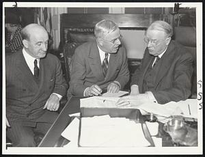 Mayor Mansfield (right) conferring with Col. Thomas F. Sulliva[n] Boston WPA administrator (left), and Lt.-Col. John J. McDonoug[h] state administrator as to just how many Bostonians will get WPA jobs from the 15,000 allotted Massachusetts yesterday by Washington.