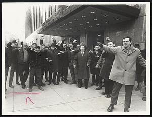 Gas workers leave John Hancock Hall after meeting was adjourned without taking back to worker vote. Workers are giving thumbs down to members of the press.