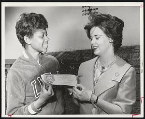 Olympic sprinting champion Wilma Rudolph, left, receives invitation to President Kennedy’s birthday dinner May 29 at Commonwealth Armory. Miss Ellen Hurley of Cambridge, daughter of the late Rudolph. Affair will be biggest birthday party in Gov. Charles E. Hurley, presents invitation to Miss New England history.