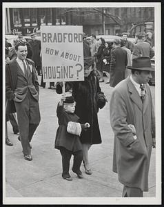 Picketing State House in a demand yesterday for action on veterans’ housing, Jean Whitehouse, petite daughter of Mrs. James Whitehouse, holds a loft a placard nearly as big as herself. Nearly 100 men and women participated and sent a delegation to Gov. Bradford with a letter.