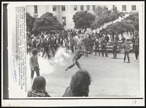 Return Fire -- An anti-war demonstrator hurls back a tear gas canister at police during violence on the University of California campus at Berkeley Wednesday when a clash broke out between militants and police after an anti-war rally.