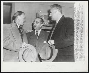 Meeting Without Smiles -- St. Louis Cards owner Fred Saigh (center) is unsmiling as he is met by Manager Eddie Stanky (left) and club vice-president William Walsingham, Jr., on arriving at LaGuardia Field here tonight from St. Louis. Saigh was sentenced yesterday to 15 months in prison and fined $15,000 for federal income tax evasion. Walsingham's name is prominently mentioned in connection with the likely sale of the Cards.