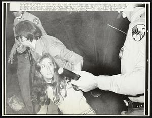 College Park, MD.: Police used tear gas against University of Maryland students 5/1 who had closed a major highway after ransacking ROTC offices protesting the sending of American troops into Cambodia. Here, a young woman is helped by her companion after falling down when police advanced on their group. Demonstrations Anti-War.