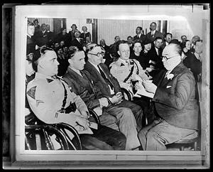 Bruno Richard Hauptmann, seated, surrounded by people