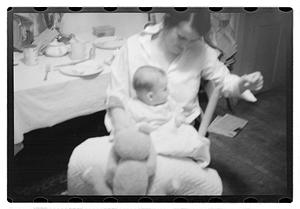Maude Sanromá holding a baby on her lap