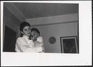 Young woman holding a baby