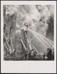 Billows of smoke pour from the John P. Squire Co. meat packing plant, as fireman battle to bring the blaze under control