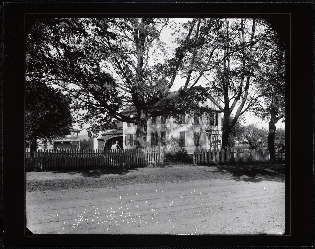 Two-story clapboard house with picket fence