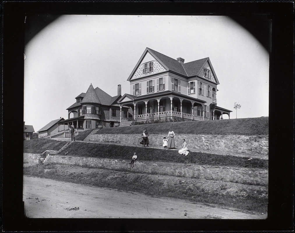 House with terraced lawn and family