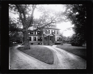 Queen Anne house with a circular drive and a large tree