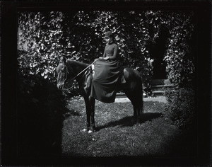 Young woman on a small black horse