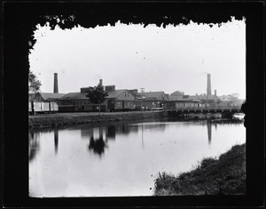 Industrial buildings and boxcars along a canal