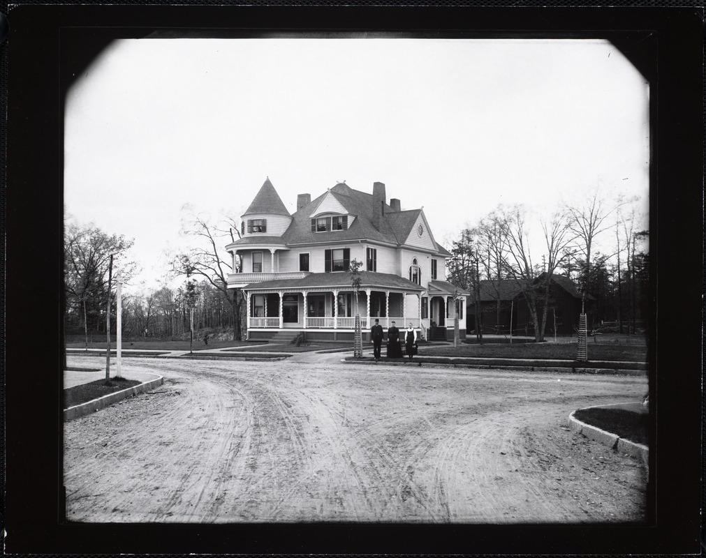 Large Queen Anne style house with family