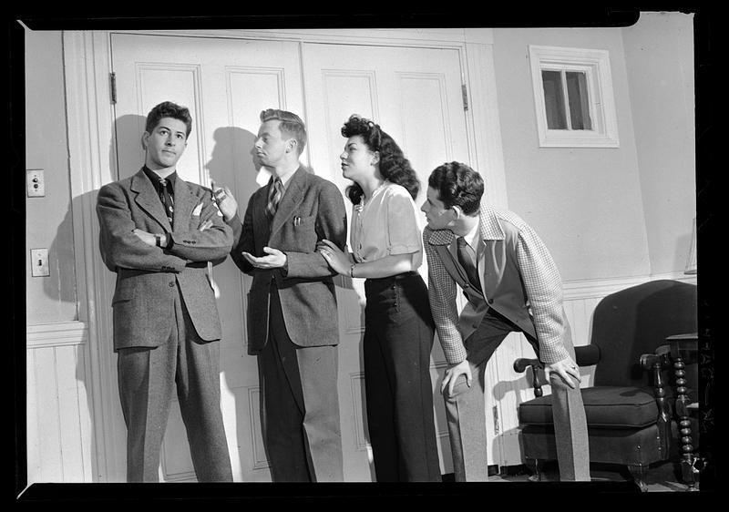 Woman and three men stand posing