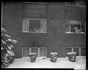 Students looking out a window at the snow