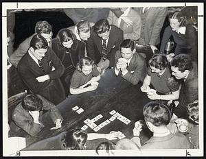 Four members of the staff of the Wellesley College News though they had “cowed” their “chums” from the Harvard Lampoon last night but the Harvards won two out of three bouts of crossword spelling in a contest staged in the Lampoon building in Cambridge. The “gallery” was large, noisy and free with advice.