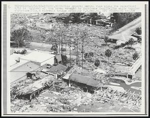 Biloxi, Miss: This general aerial view along the waterfront 8/18 is typical of the havoc wrought by Hurricane Camille. The white tubular structure (C) is a sidewalk bridge crossing U.S.HWY.90.