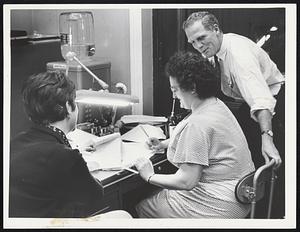 Secretary Supervises -- State Secretary Kevin H. White joins Theresa Mustone of Boston, center, and Ann Denehy of Brighton, in engrossment office as his staff workers correct working drafts of legislation passed minutes earlier by the Legislature.