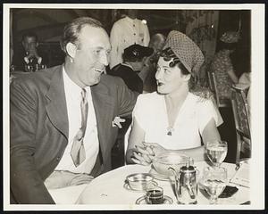 Yankee Mound Ace Celebrates 14th Voctory. Charley (Red) Ruffing, New York Yankees pitching star, is shown with mrs. Ruffing, July 26, at the starlight roof of the Waldorf Astoria, New York, celebrating his victory earlier in the day over the St. Louis Browns. It was Ruffing's 14 victory of the season. He has lost three games.