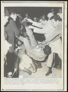 Put-Down for a Protestor--New York City plain-clothes policemen deposit a student protester on the ground, but not too gently, after he and others holding sit-ins in Columbia University buildings were removed by the police this morning.