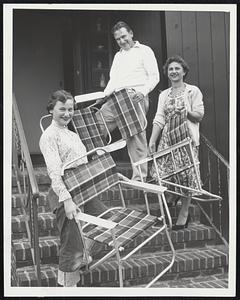 Summer's Over-Mr. and Mrs. Vincent Canavan and their daughter, Lana, 13, of Revere, move patio furniture indoors in preparation for the expected arrival of Hurricane Edna. Canavan is a Boston attorney.