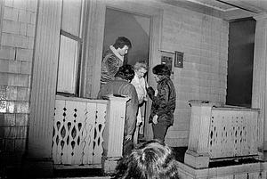 Off duty Chelsea firefighter Ron Nemic, civilian Arthur Rosenberg, and an unknown civilian evacuate Betsy Siegal from her home