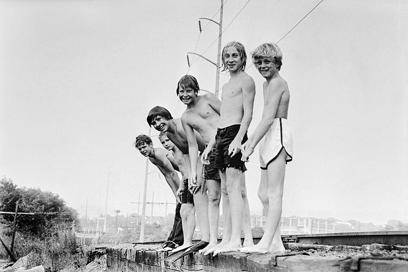 Kids swimming on railroad bridge