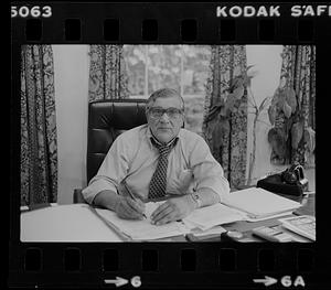 Peter Matthews at desk in office