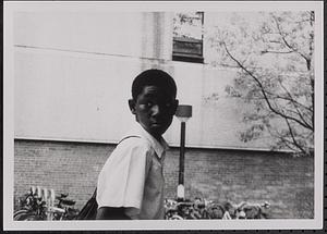 Boy walking past bike racks