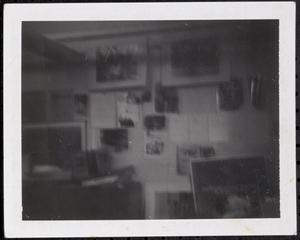 Papers and photos hanging on wall