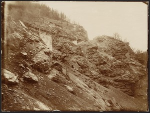 View of a rocky slope with wooden tracks/bridge