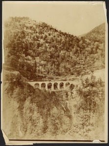 Arched viaduct on mountain, sheer cliff below
