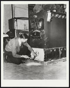 Oil Users Might Try Wood. New Haven, Conn. - A burning unit which may be attached to almost any oil or coal installation for about $60 is jointly offered by the Connecticut Agricultural Experiment Station and The Mason Laboratory of Yale University. Conversion from oil burner to wood is described as "fairly simple." The first step is taken by A.R. Olson, Research Technician at the station. He cold chisels his way into sealed-up fire box of oil burner.