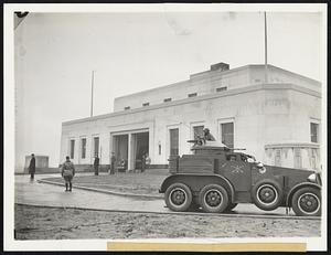 Troops Guard Gold Transfer. Ft. Knox, Ky., Jan. 14 -- The First Cavalry, Mechanized, turned out to protect the huge gold shipment that arrived here yesterday from Philadelphia. A modern combat car is shown on duty at the right as two trucks loaded with gold stand in the Entrance to the Government's new vaults for unloading.