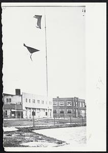 Hurricane warning flags at Freeport, Tex., are tattered by advance winds from Hurricane Carla. Town was evacuated.