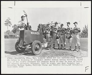 Bradenton, Fla. – Waner Shows Off His Machine – Paul Waner, who helps in training of Milwaukee Braves during spring training, shows some of the club’s pitchers his machine which is used to toss up balls for bunting practice. Pitchers, left to right, are Chet Nichols, Lew Burdette, Warren Spahn, Phillips Paine and Charles Gorin.