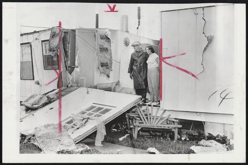 Thomas Prince and his daughter, Carol, view damage to their home by one of several tornadoes which skipped through Chicago suburbs. A dozen other homes were damaged in Sauk Village, III.