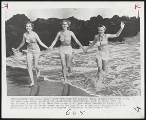 Asbury Park, N.J. - It's Very Warm For January - Three bathing girls romp along the beach here today, enjoying the unseasonably warm weather. Left to right, they are: May Poulsen, Elberon, N.J.; Karen Dane, Avon, N.J., and Jeanne DeMarky of Asbury Park. Temperature along the Jersey coast was in the high 60's. In New York City, about 60 miles north of here, it was a record 65.6 degrees.