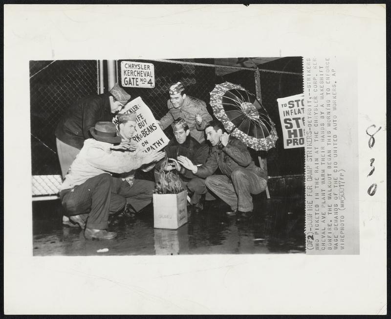 Bonfire for Damp Strikers – Detroit, – Strikers who picketed in the rain at the Chrysler Corp. Kercheval Ave plant warm their hands by a makeshift bonfire. The walkout began this morning to enforce wage demands of the CIO united auto workers.