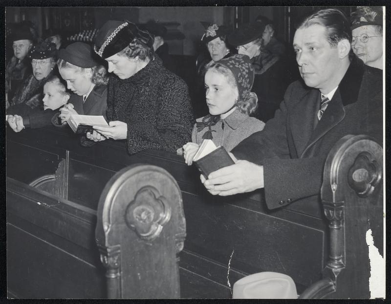 Governor-Elect Tobin at Pre-Enaugural Devotions-Gov.-Elect Maurice Tobin, Mrs. Tobin and their three children (left) attend Mass at the Mission Church, Roxbury, as fitting start for the day of his inauguration. After Mass, the Governor-elect lights a vigil light (right) at the Shrine of Our Lady of Perpetual Help in the church.