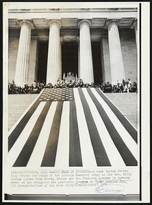 The Flag in Evidence-- A huge United States flag fronts the steps of the Lincoln Memorial today as the Rev. Billy Graham speaks from above. Graham was the featured speaker in opening event on the religious and patriotic program on Honor America Day.